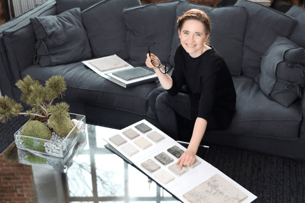 Interior Designer sitting on couch with fabric
