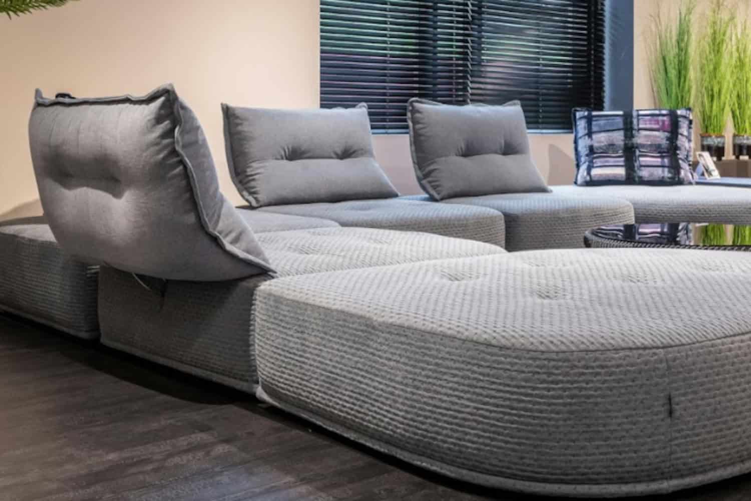 Grey D-shaped cushion on a sectional sofa